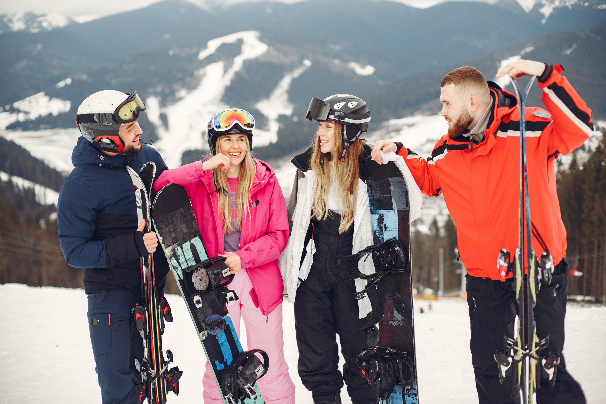 people snowboarding in the mountains with the snowboard
