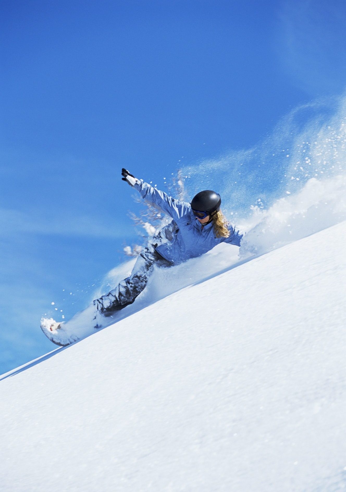 young woman snowboarding e1635489715352